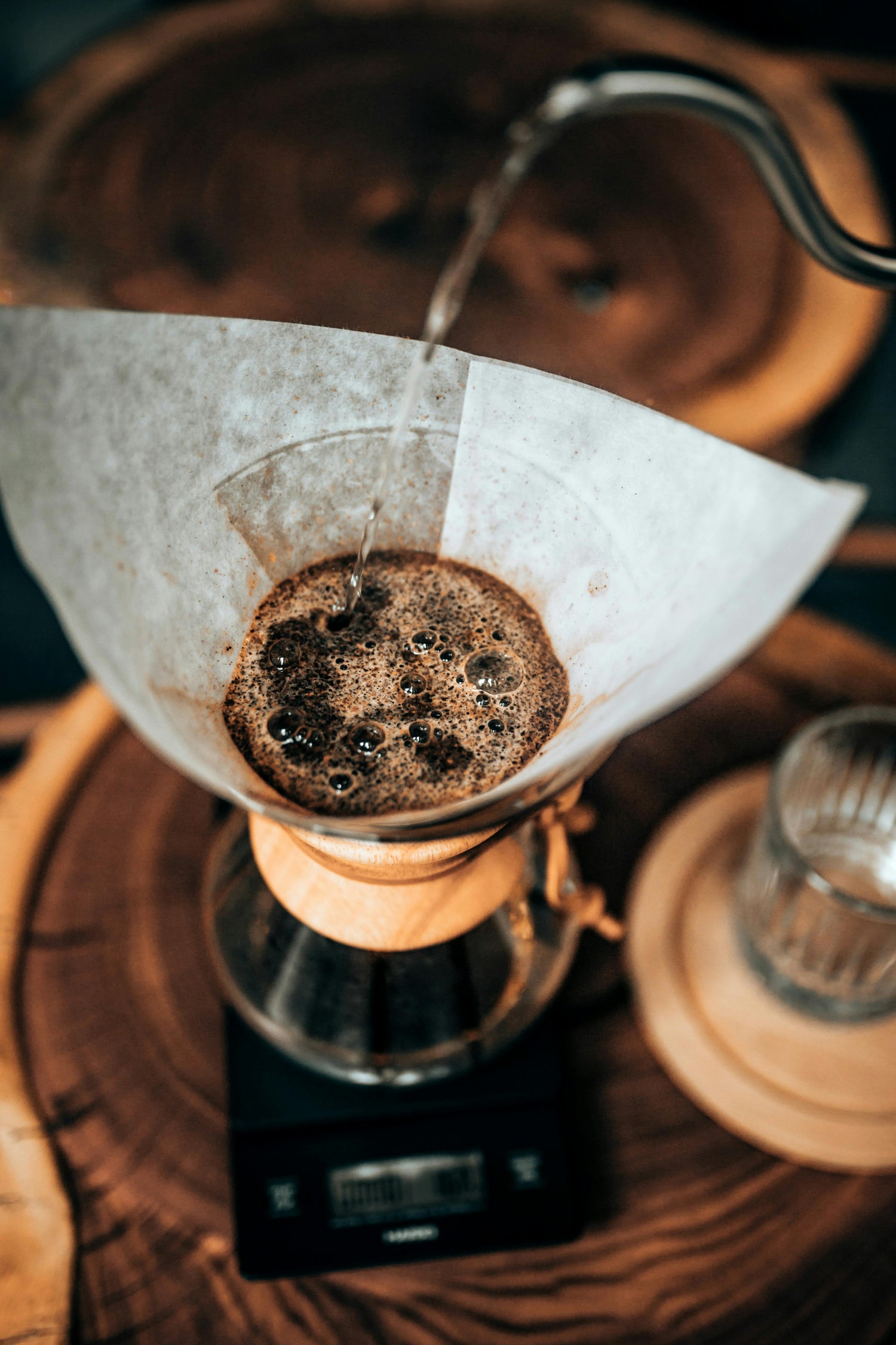 Coffee being brewed with a paper filter on a wooden surface
