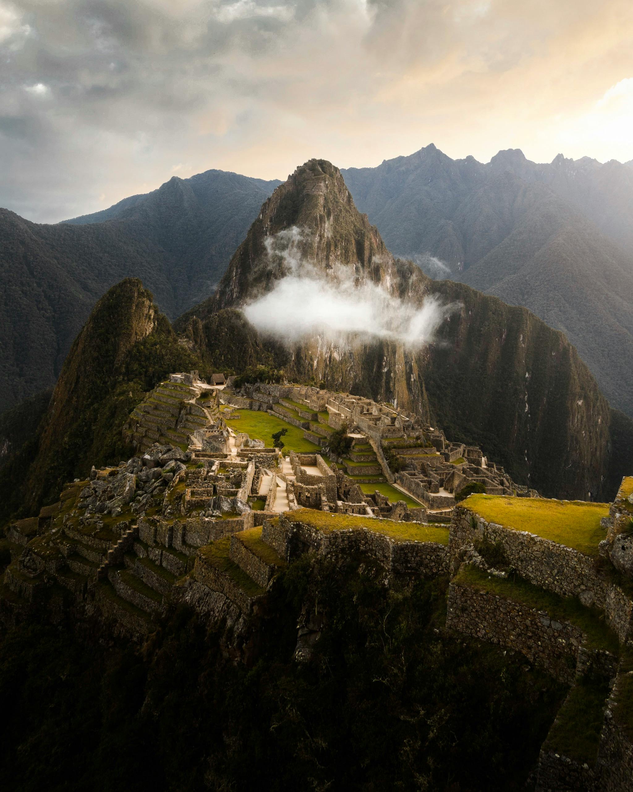 Machu Picchu with misty mountain peaks in the background