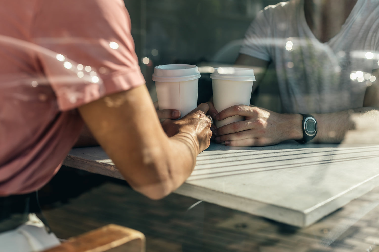 Two people enjoying take away cups of Brewno Specialty Coffee